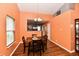 Bright dining area with a modern chandelier and wood floors, next to kitchen at 921 Kimberly Ave, Westfield, IN 46074