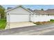This home features an attached two-car garage and white privacy fence at 921 Kimberly Ave, Westfield, IN 46074