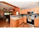 Open concept kitchen with stainless steel appliances and view into the living room at 921 Kimberly Ave, Westfield, IN 46074