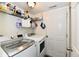 This home's laundry room includes modern machines, shelving, and access to the exterior at 921 Kimberly Ave, Westfield, IN 46074