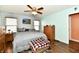 Comfortable main bedroom features a ceiling fan, wood-look floors, and fresh, neutral paint at 921 Kimberly Ave, Westfield, IN 46074