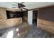 Living room featuring wood paneled walls and an opening to an adjacent space at 100 N Blue River Dr, Edinburgh, IN 46124