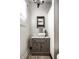 Charming bathroom featuring a pedestal sink, wainscoting, and stylish mirror at 1044 E Garfield Dr, Indianapolis, IN 46203