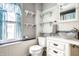 Bright bathroom with bead-board walls, glass bowl sink, and open shelving at 1044 E Garfield Dr, Indianapolis, IN 46203
