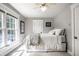 Cozy bedroom with natural light, comfortable bed, and neutral decor at 1044 E Garfield Dr, Indianapolis, IN 46203