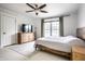 Bright bedroom with hardwood floors, large window, and ceiling fan at 1044 E Garfield Dr, Indianapolis, IN 46203