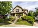 Charming two-story home with a landscaped front yard, brick accents, and a welcoming front porch at 1044 E Garfield Dr, Indianapolis, IN 46203
