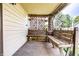 Inviting front porch featuring a comfortable wooden bench and decorative lattice accents for added appeal at 1044 E Garfield Dr, Indianapolis, IN 46203