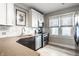 Bright kitchen with white cabinets, stainless steel appliances, and stylish tile backsplash at 1044 E Garfield Dr, Indianapolis, IN 46203