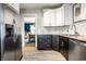 Kitchen view with stainless steel refrigerator and view into dining area at 1044 E Garfield Dr, Indianapolis, IN 46203