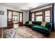 Elegant living room with hardwood floors, decorative columns, and comfortable green sofa with pillows at 1044 E Garfield Dr, Indianapolis, IN 46203