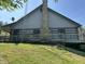 Rear view of a log cabin featuring a stone chimney, siding, and elevated deck at 10770 W 650 S, Columbus, IN 47201