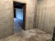 A look through a doorframe into a basement space with a concrete floor and unfinished walls at 10770 W 650 S, Columbus, IN 47201