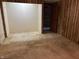 Unfinished basement area with wood paneling, showing access to another room or closet at 10770 W 650 S, Columbus, IN 47201