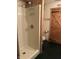 Full bathroom with stand-up shower, toilet, and dark green flooring at 10770 W 650 S, Columbus, IN 47201