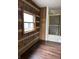 Unique bathroom with log walls, built-in storage, and a glass door shower at 10770 W 650 S, Columbus, IN 47201