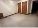 Bedroom featuring neutral carpet and decorative wood closet doors at 10770 W 650 S, Columbus, IN 47201