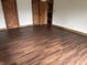 Spacious bedroom with rich-toned wood floors and striking wood doors at 10770 W 650 S, Columbus, IN 47201