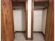 A shot of two closets with wooden doors and a single shelf with a metal rod underneath in each closet at 10770 W 650 S, Columbus, IN 47201
