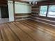 Dining room featuring wood floors, log walls, and a view of the backyard at 10770 W 650 S, Columbus, IN 47201