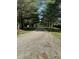 View of a gravel driveway lined with mature trees leading to the property at 10770 W 650 S, Columbus, IN 47201