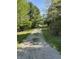 Long gravel driveway leading through a tree-lined property at 10770 W 650 S, Columbus, IN 47201