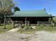 Cozy log cabin with a green metal roof and inviting front porch at 10770 W 650 S, Columbus, IN 47201