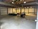 Spacious garage interior with open framing and concrete floor at 10770 W 650 S, Columbus, IN 47201