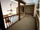 A hallway featuring wooden railing and exposed wooden beams above at 10770 W 650 S, Columbus, IN 47201