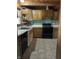 Close-up of the kitchen with wooden cabinets and black appliances at 10770 W 650 S, Columbus, IN 47201