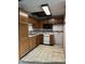 Compact kitchen featuring wood cabinets, appliances, and a retro design, ready for updating at 10770 W 650 S, Columbus, IN 47201