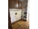 Laundry room with overhead cabinets and utility connections at 10770 W 650 S, Columbus, IN 47201