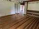 Open living room featuring wood floors and an open doorway at 10770 W 650 S, Columbus, IN 47201