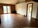 Open living area featuring hardwood floors, lake view, and sliding doors to the deck at 10770 W 650 S, Columbus, IN 47201