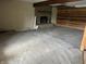Spacious living area with stone fireplace and wood paneling, awaiting renovation at 10770 W 650 S, Columbus, IN 47201