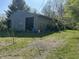 Exterior of a storage building featuring a sliding door and a grassy surround at 10770 W 650 S, Columbus, IN 47201