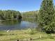 Picturesque pond view showcasing mature trees and a tranquil setting enhancing the property's appeal at 10770 W 650 S, Columbus, IN 47201
