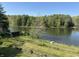 Beautiful waterfront property with a pond, old cabin, and a serene backyard at 10770 W 650 S, Columbus, IN 47201