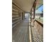 Expansive covered porch with wooden flooring and rustic log accents, great for relaxing at 10770 W 650 S, Columbus, IN 47201