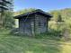 Quaint log shed featuring classic log cabin construction and lake view at 10770 W 650 S, Columbus, IN 47201