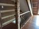 A wooden staircase featuring detailed wooden railings and hardwood flooring at 10770 W 650 S, Columbus, IN 47201