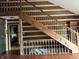 Wooden staircase with railing, highlighting the rustic interior of the home at 10770 W 650 S, Columbus, IN 47201