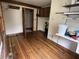 Versatile utility room featuring shelving, wood flooring, and rustic accents at 10770 W 650 S, Columbus, IN 47201