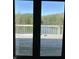 Inviting view from the deck overlooking a serene lake and lush greenery at 10770 W 650 S, Columbus, IN 47201