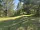Lush green yard surrounded by trees, offering a peaceful and serene environment at 10770 W 650 S, Columbus, IN 47201