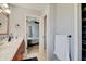 Bathroom featuring vanity with sink, and open access to a bedroom and closet at 11124 Winterwood Dr, Indianapolis, IN 46235