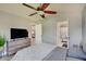 Bedroom featuring carpet, ensuite bathroom, a ceiling fan, and natural light at 11124 Winterwood Dr, Indianapolis, IN 46235