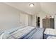Cozy bedroom featuring neutral paint, sloped ceiling, and an organized closet for functional living at 11124 Winterwood Dr, Indianapolis, IN 46235
