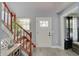 Beautiful foyer with light gray walls, hardwood floors, white trim, and view of the staircase at 11124 Winterwood Dr, Indianapolis, IN 46235