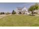 Beautiful white two-story home with a landscaped yard, covered porch, and a side-entry two-car garage at 11124 Winterwood Dr, Indianapolis, IN 46235